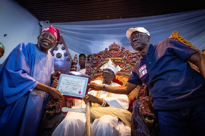 Nigeria's President Elect, Bola Ahmed Tinubu in the company of the Lagos State Governor, Baba-Jide Sanwo Olu, presents his Certificate of Returns to the Oba of Lagos, Oba Rilwan Akiolu in his palace.